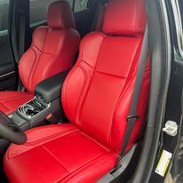 The seats are red and the steering wheel is black