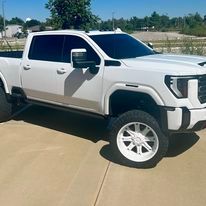 A white pickup truck is parked in a parking lot