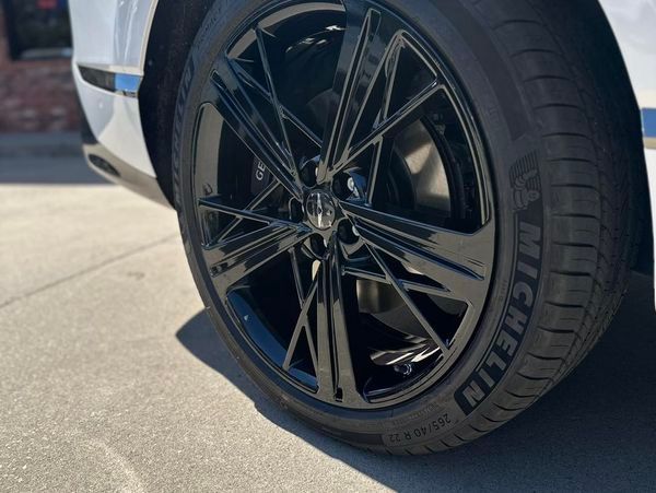 A close up of a michelin tire on a white car
