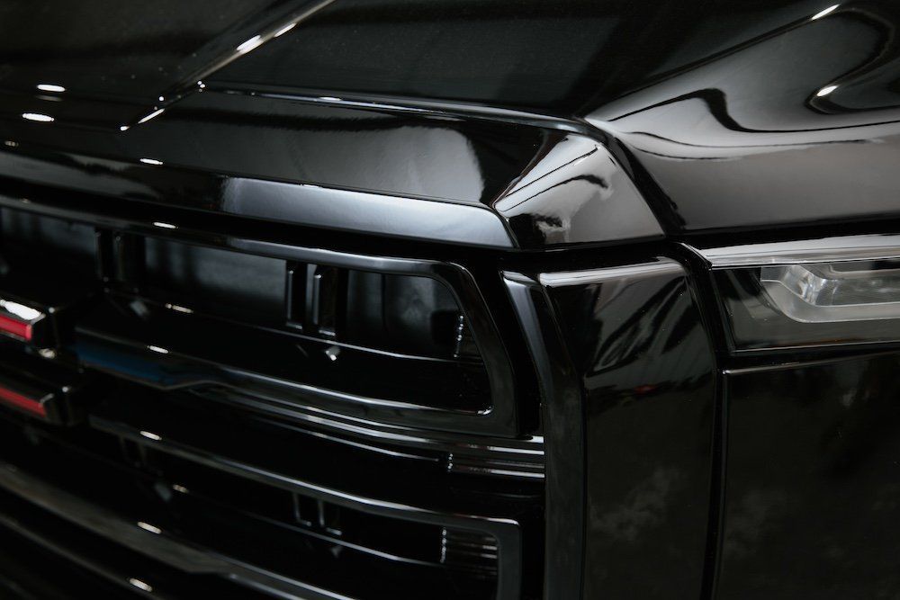 A close up of the front of a black truck