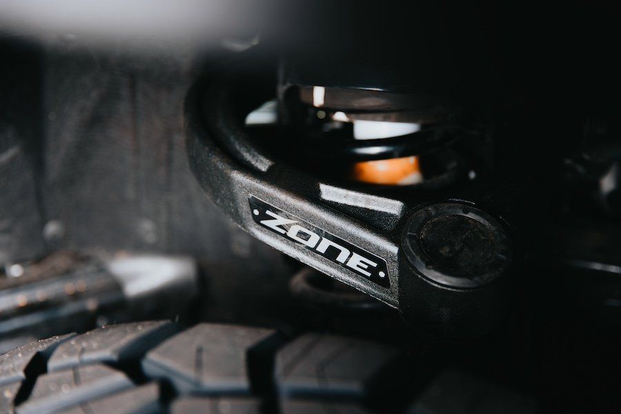 A close up of a shock absorber on a vehicle.