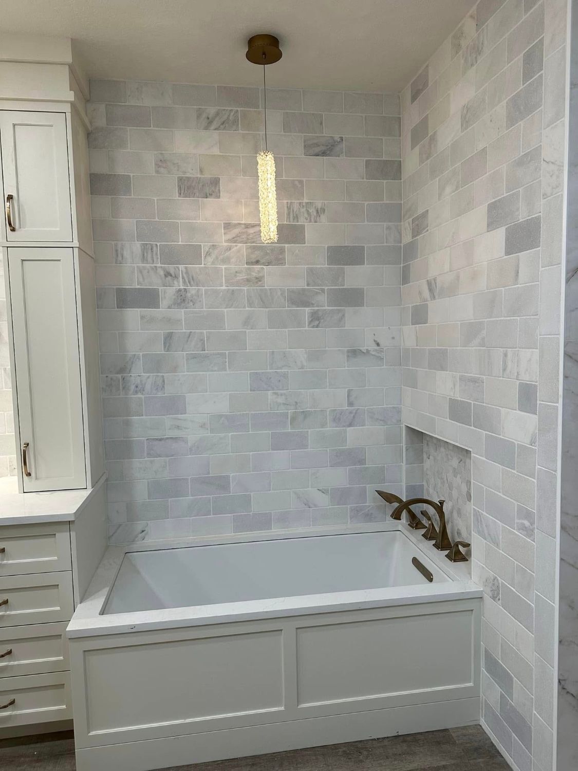 A bathroom with a bathtub and a shower.