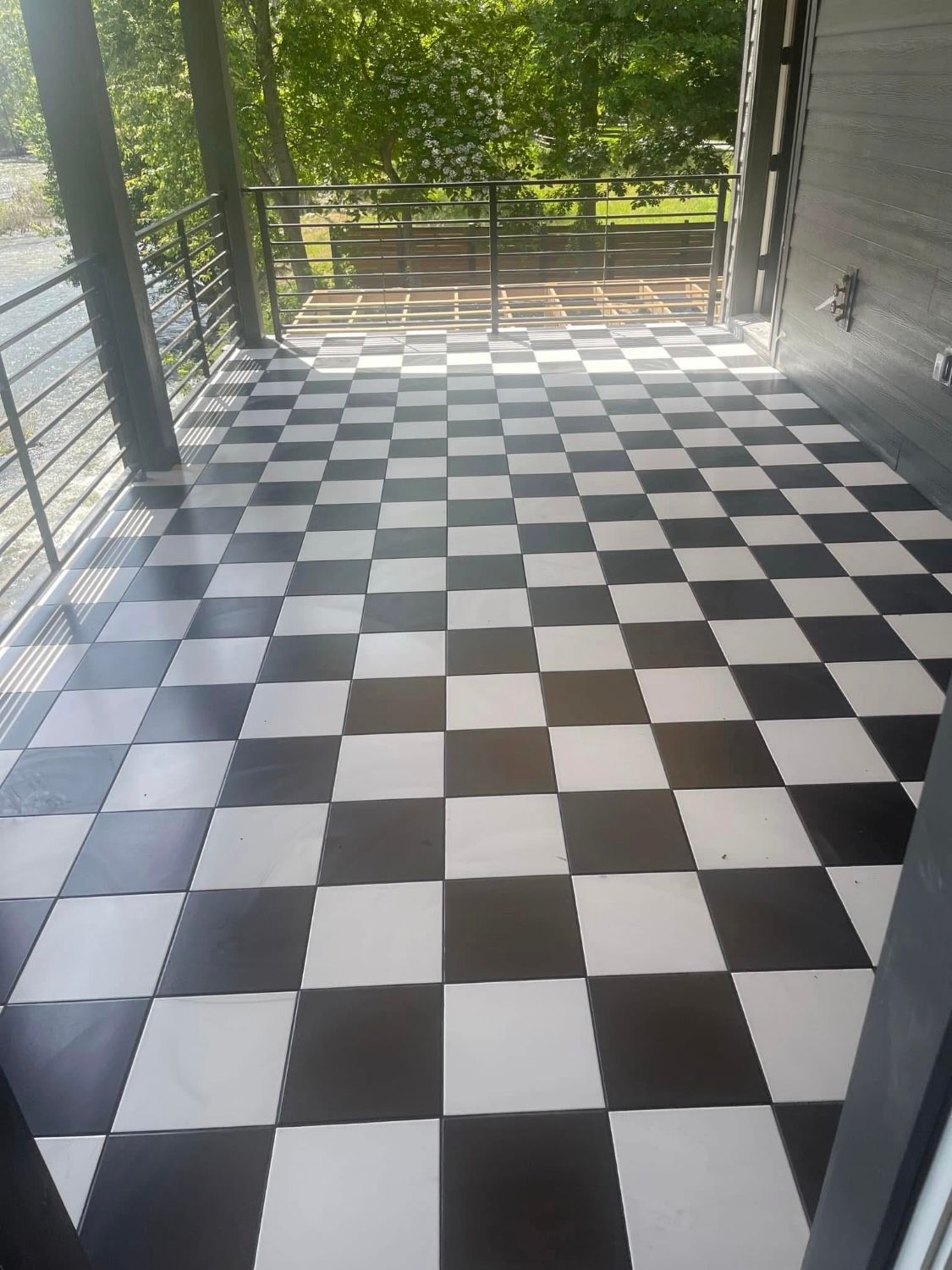A black and white checkered floor on a balcony