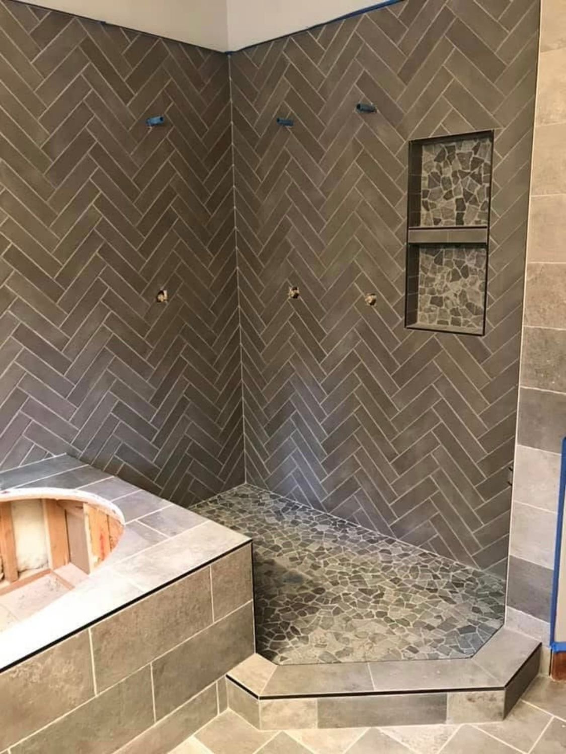 A bathroom with a walk in shower and a bathtub.