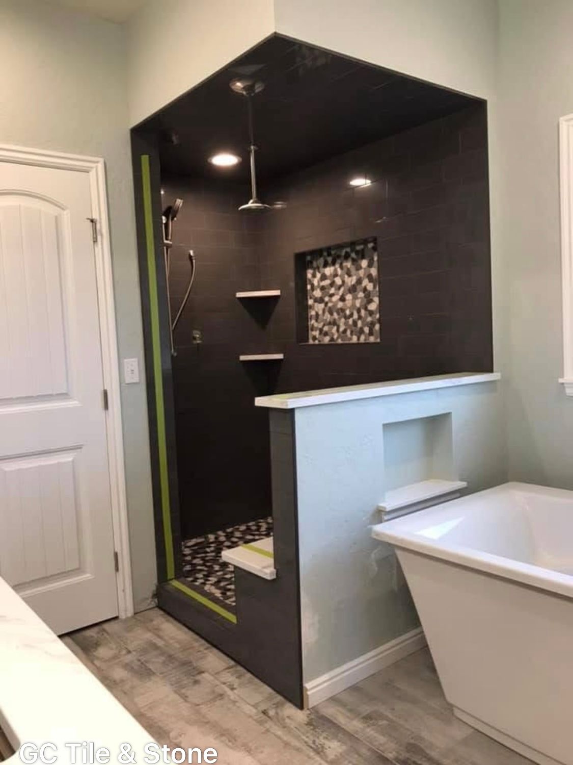 A bathroom with a walk in shower and a bathtub.