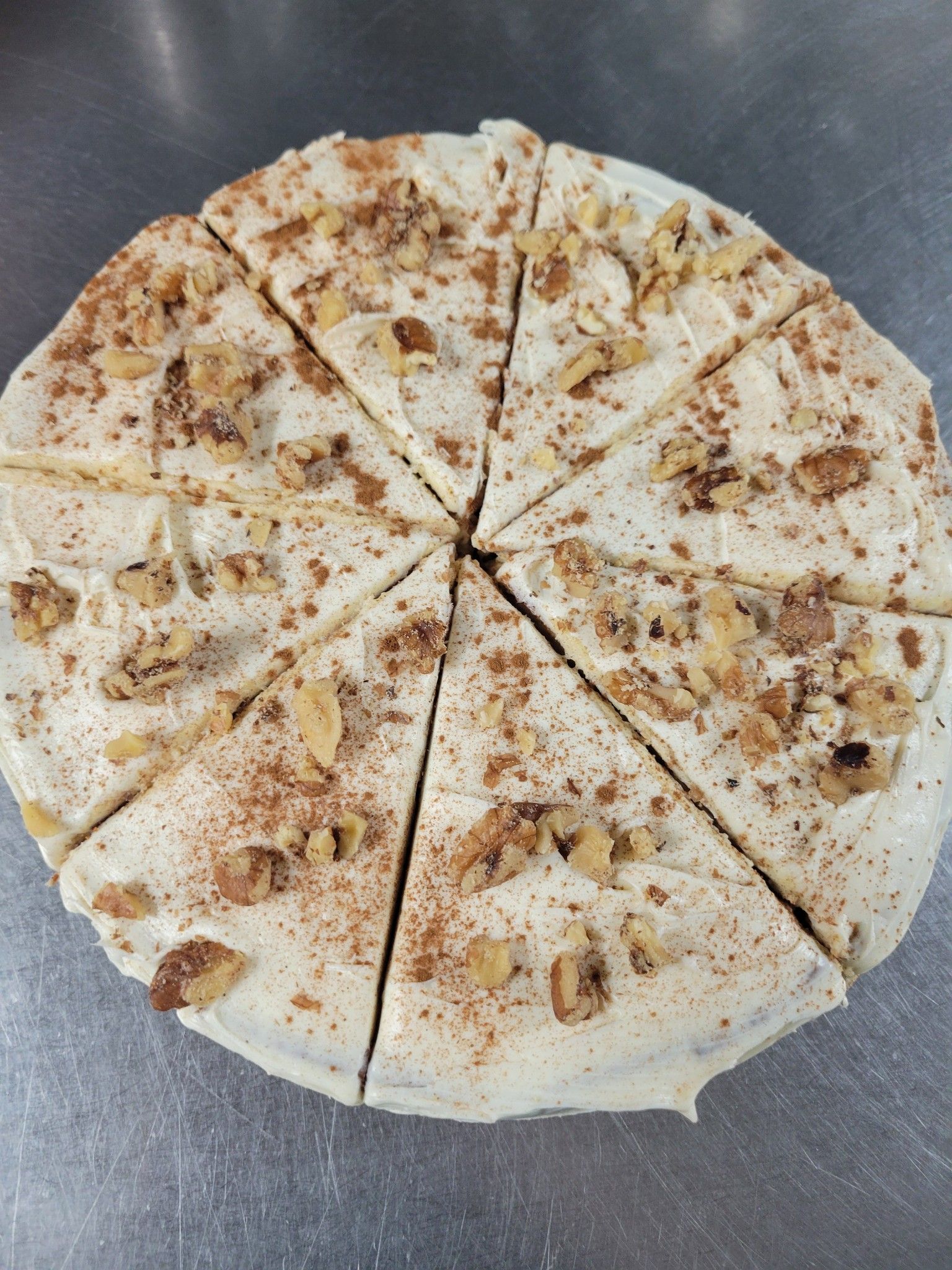 A whole cheesecake with slices cut out of it is sitting on a table