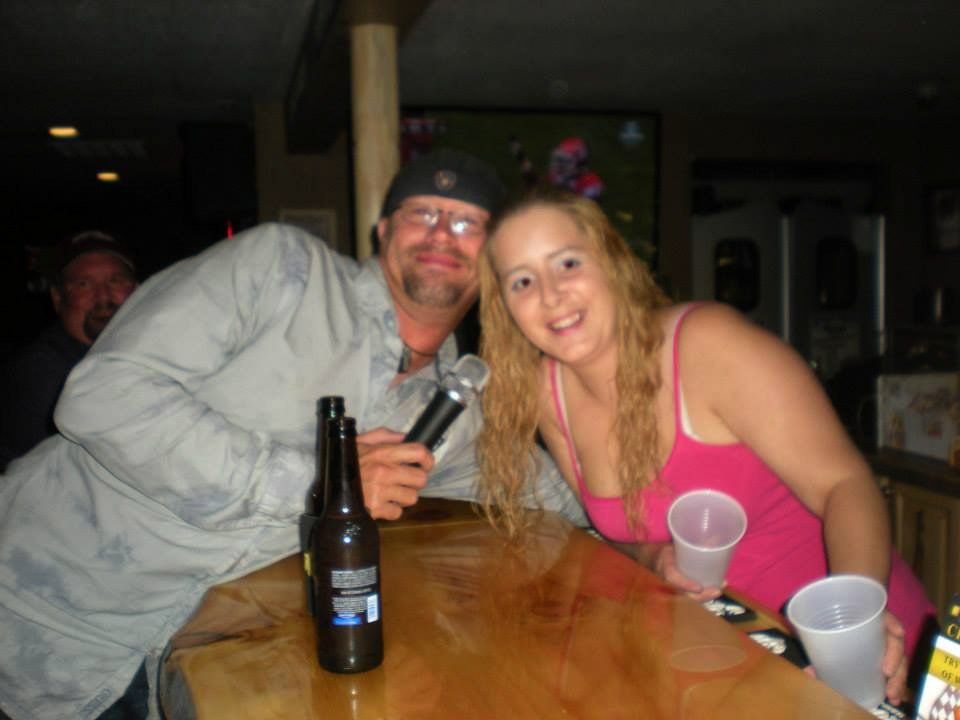 Man and women singing and smiling