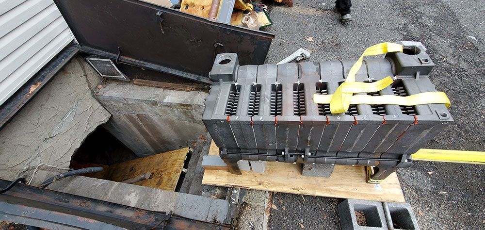 A large piece of metal is sitting on top of a wooden pallet.