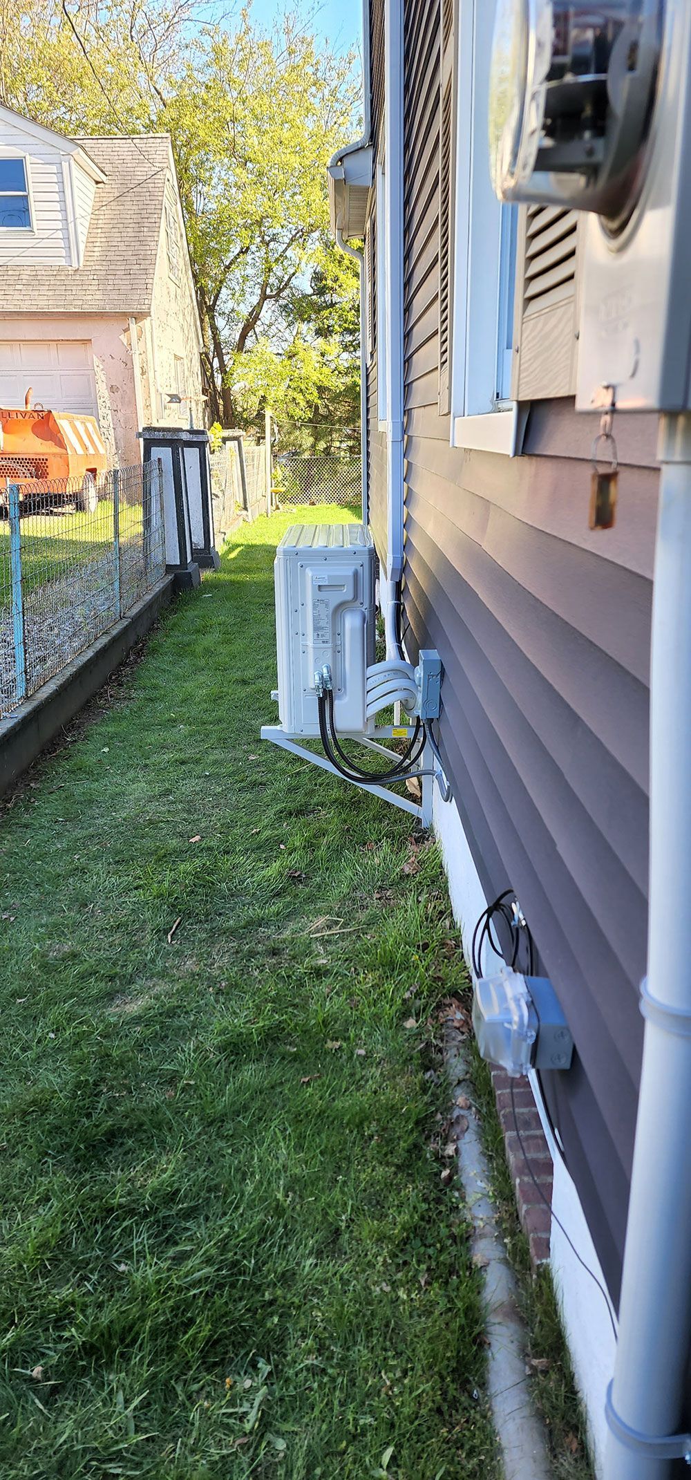 A house with a lot of grass on the side of it.