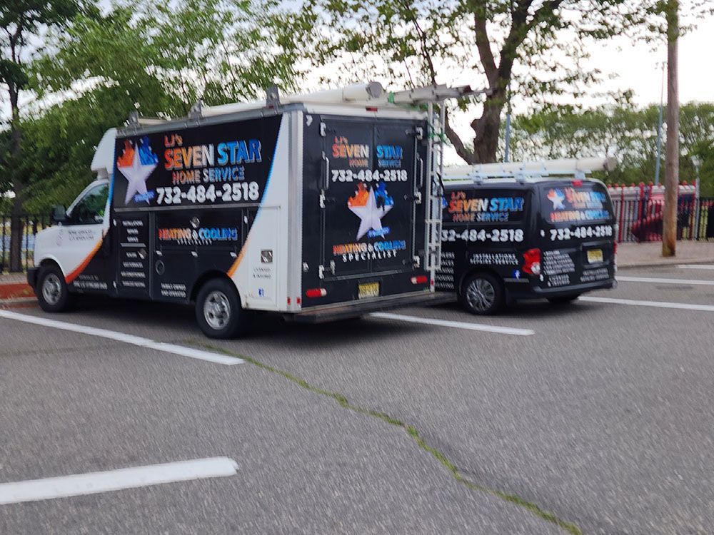 Two seven star vans are parked on the side of the road