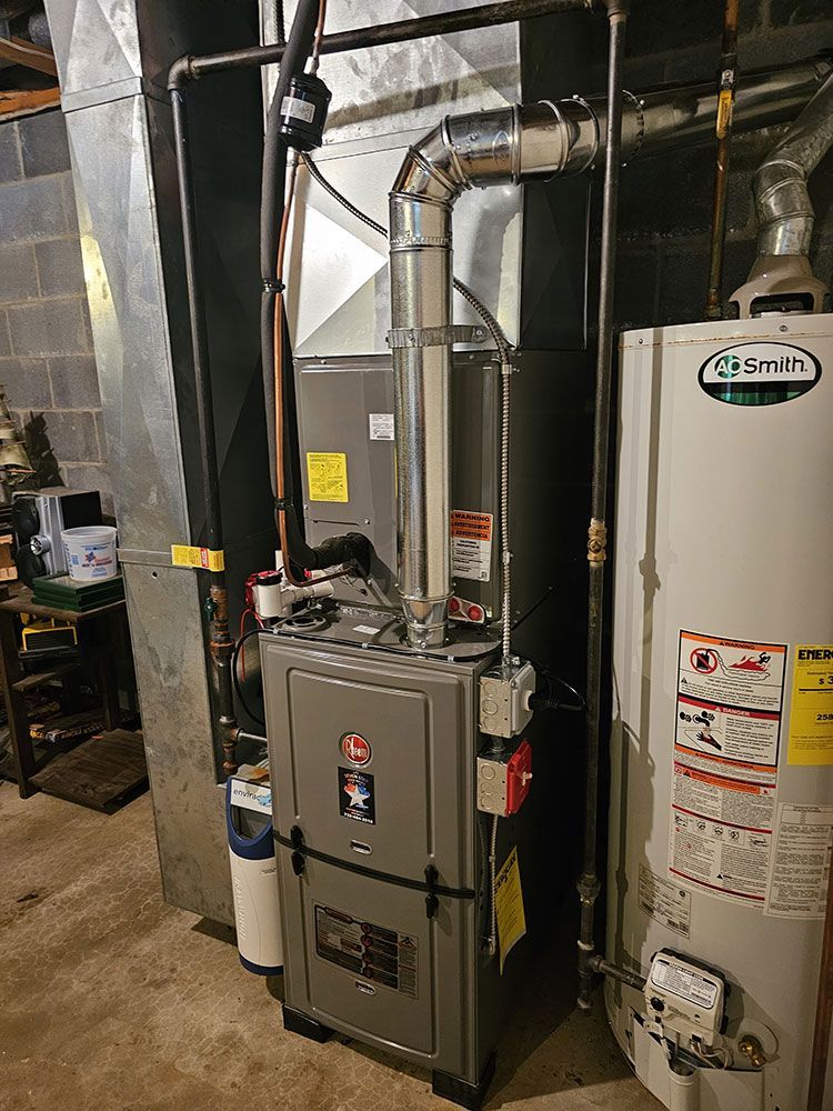 A gas heater and a water heater are in a basement.