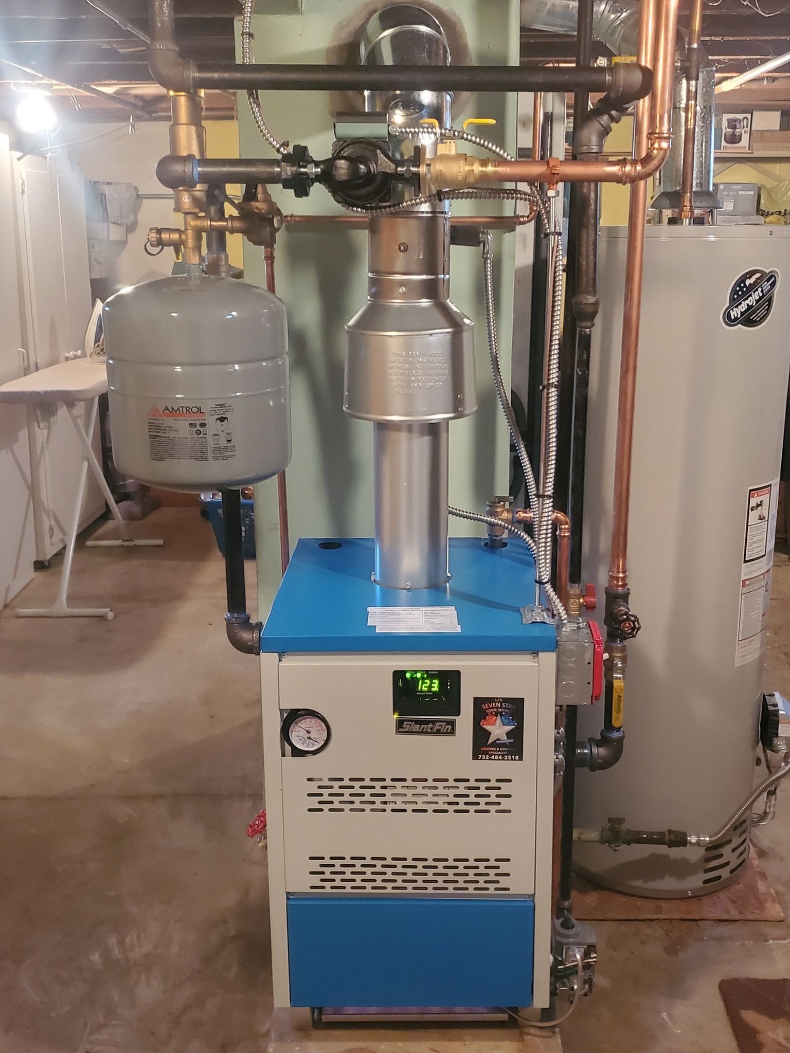 A blue and white boiler with a clock on it