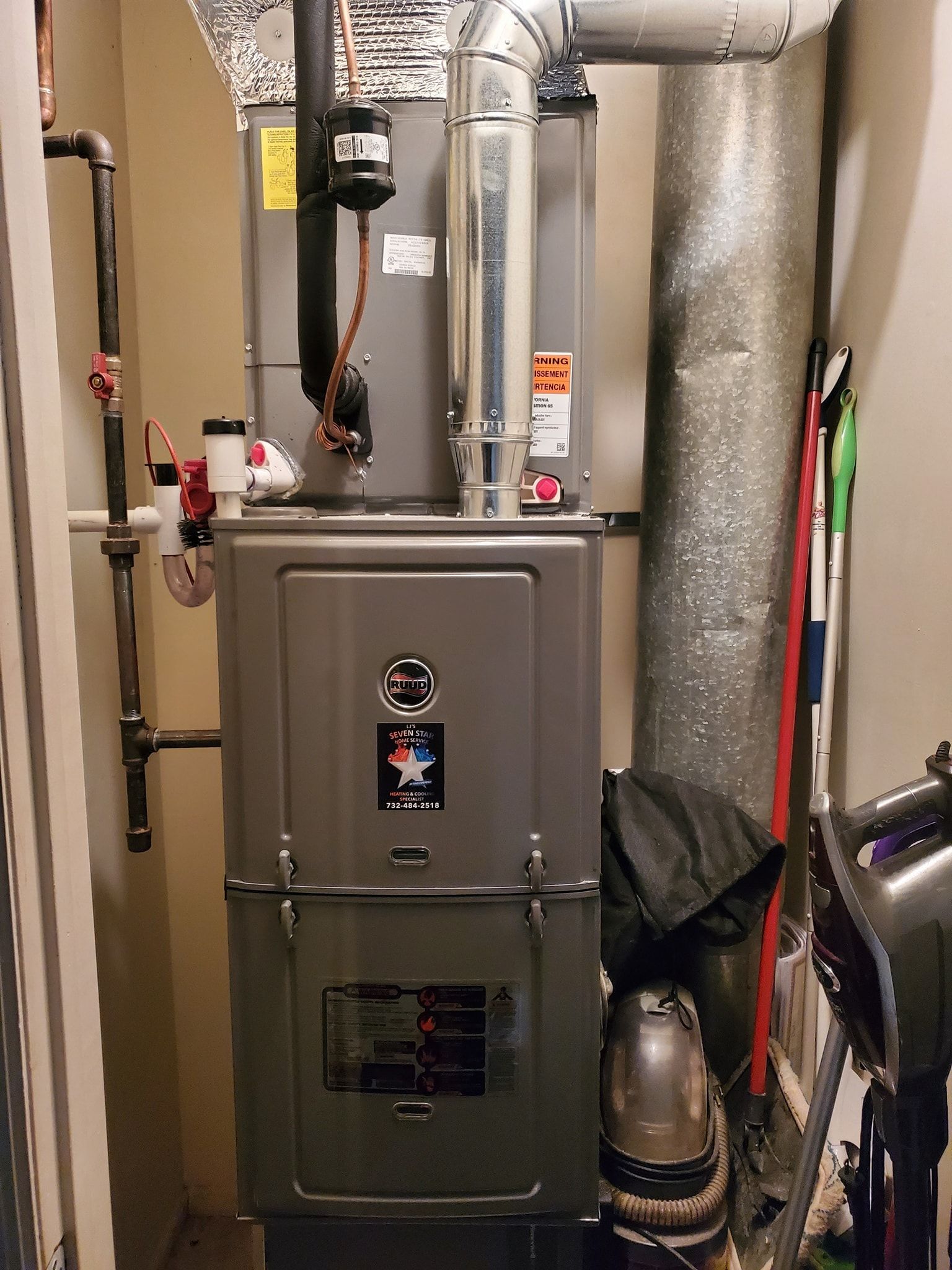 An air conditioner is sitting in a corner of a room.