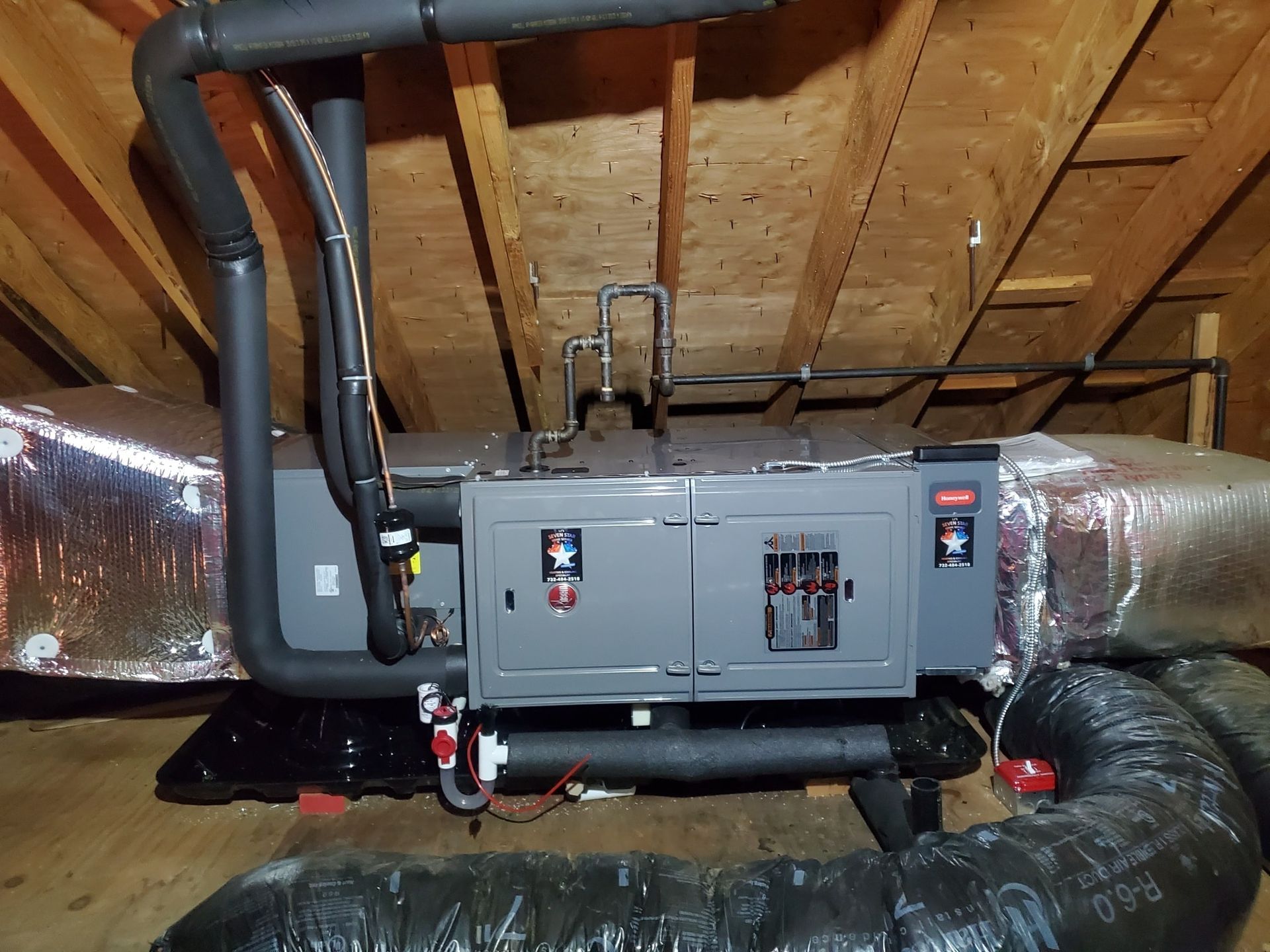 An air conditioner is installed in the attic of a house