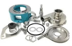 Assorted metal mechanical fittings and flanges, including a blue bearing housing, on a white background.