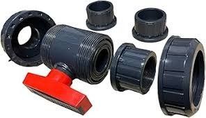 Assorted black PVC pipe fittings, including couplings and an elbow valve, on a white background.