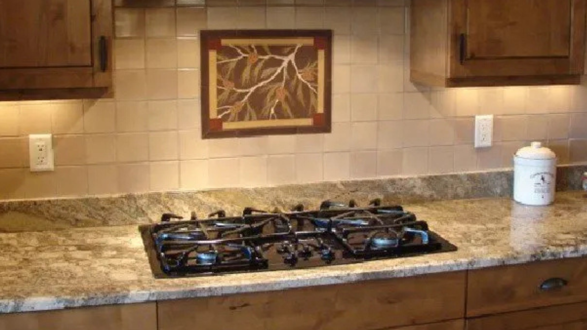 Custom granite countertop with precise cooktop cutout and polished edge in a Prescott AZ kitchen.