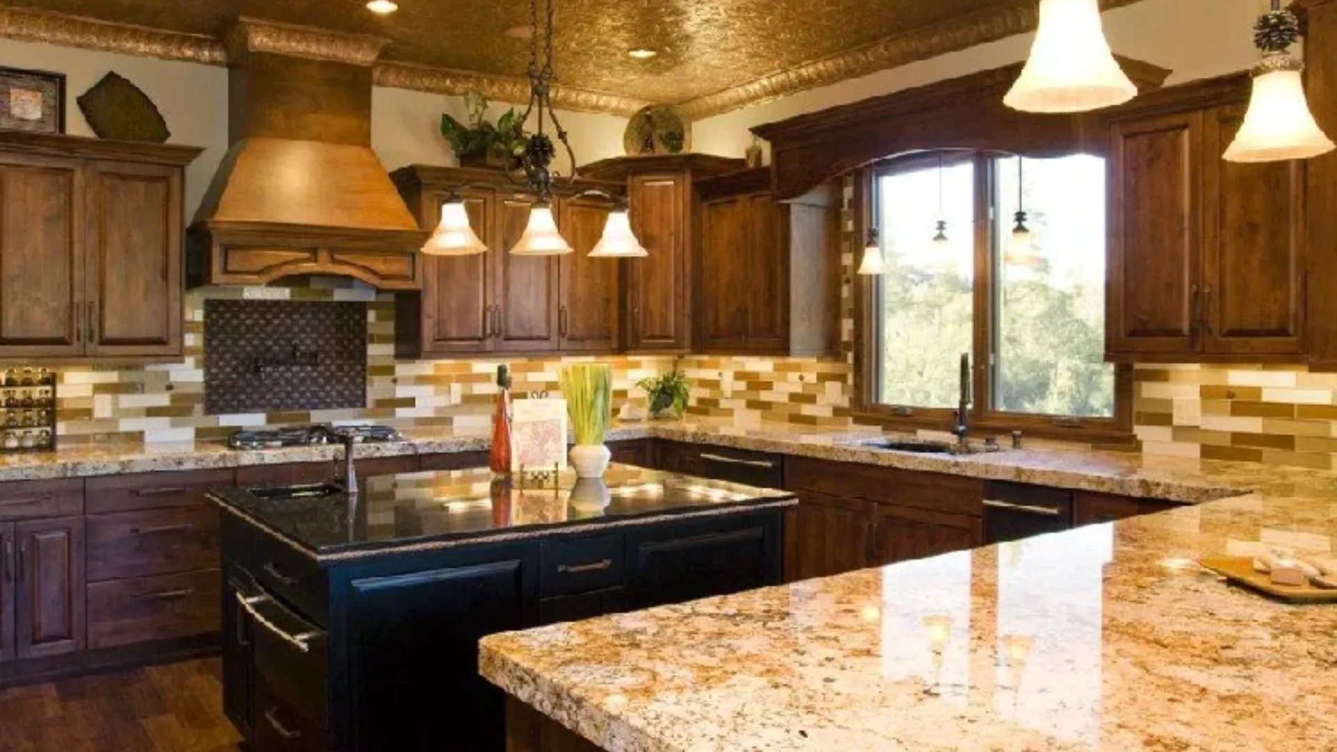 Spacious kitchen with wood cabinets, granite countertops, and a central island under warm pendant lights