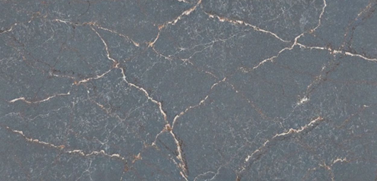 Dark grey stone surface with thin, branching white and gold veins resembling marble.