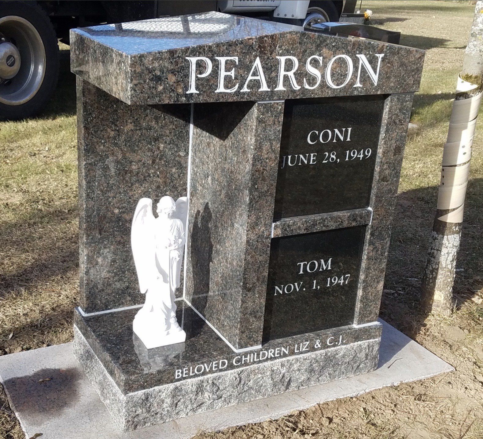 Dark granite tombstone with 
