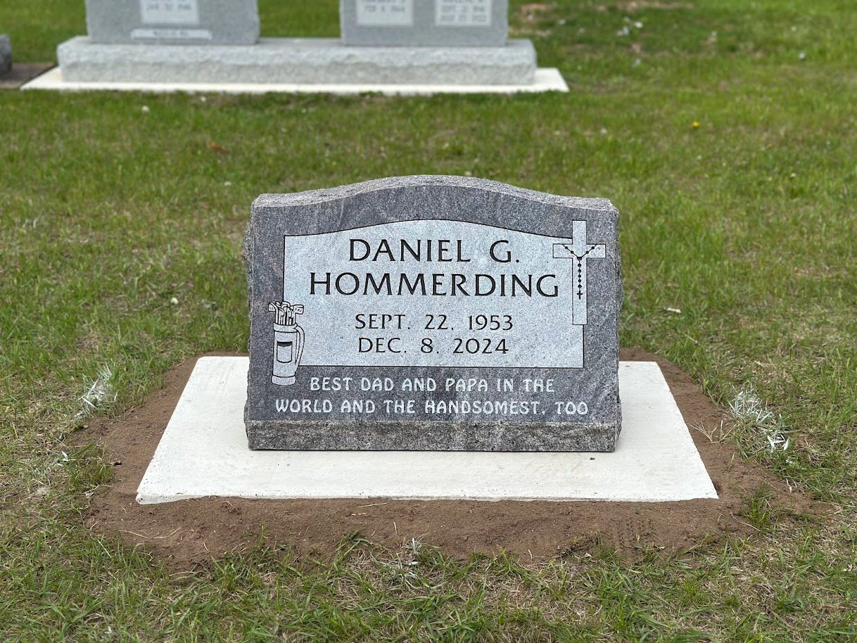 Grave marker for Daniel G. Hommerding; gray stone with dates Sept. 22, 1953 - Dec. 31, 2021. Inscription at the bottom.