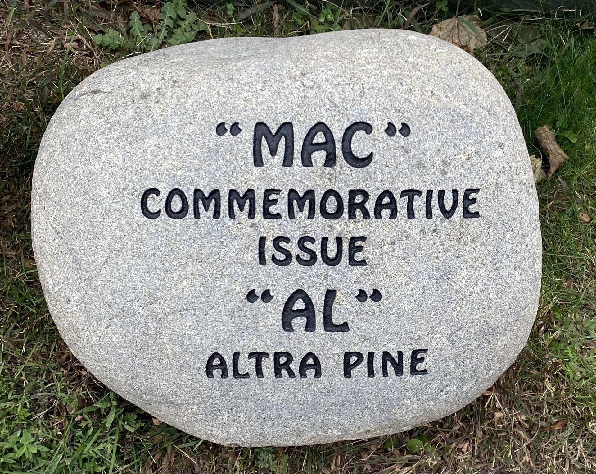 Gray stone with engraved text: 