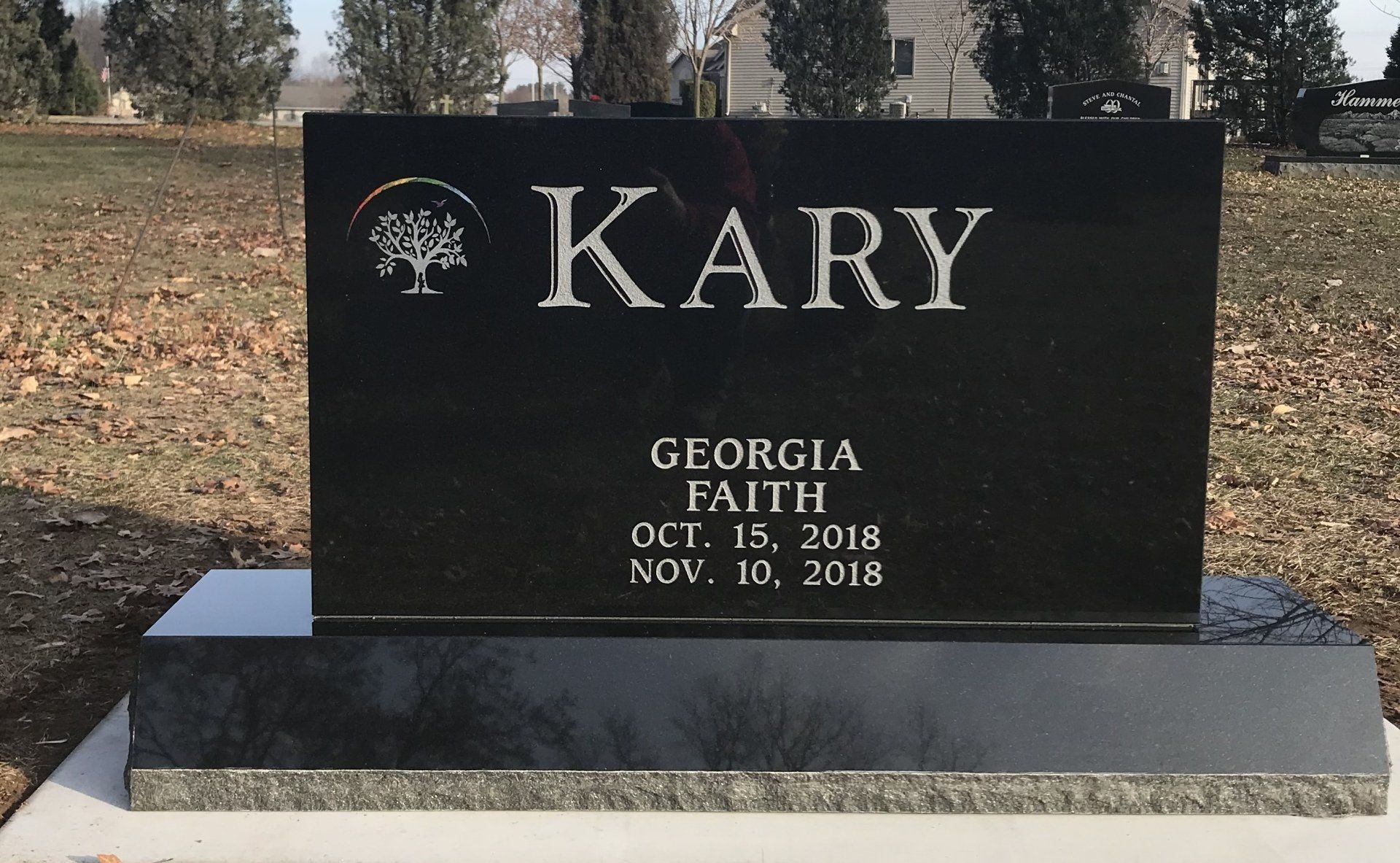 Black granite headstone with the name 