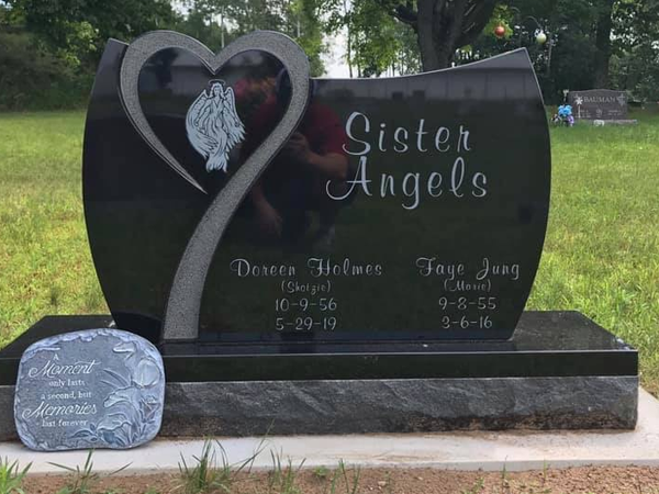 Black headstone with heart design and names 