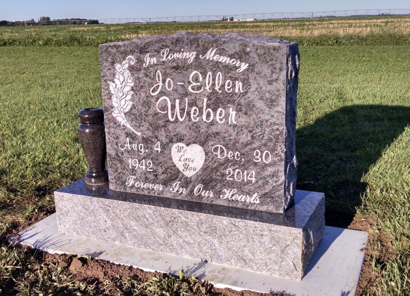 Headstone of Jo-Ellen Weber: black granite, engraved name, birth/death dates, and memorial text in a field.