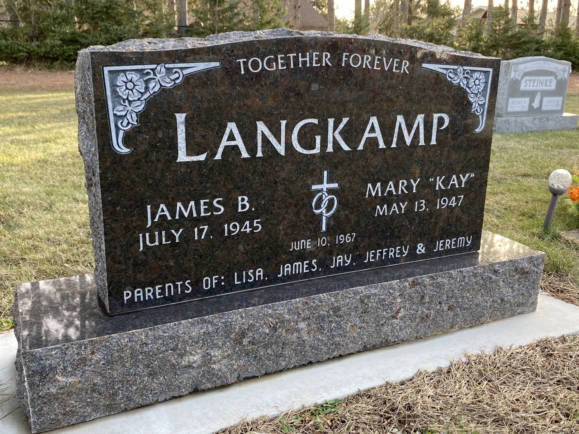Headstone for Langkamp family. Black granite with white lettering. Inscription includes names, dates, and 