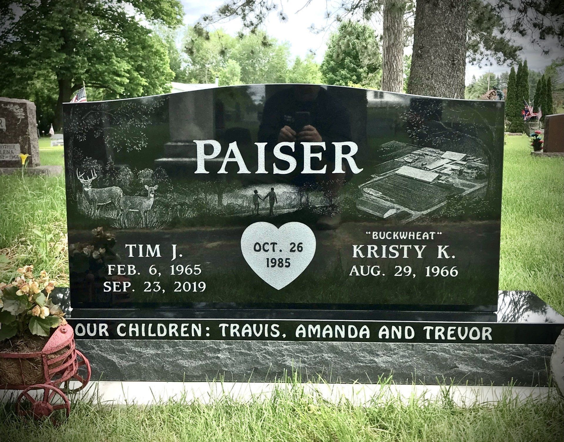 Headstone for the Paiser family in a cemetery. Includes names, dates, and drawings.