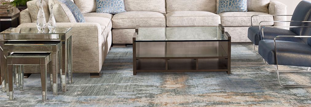 A living room filled with furniture and a glass coffee table.
