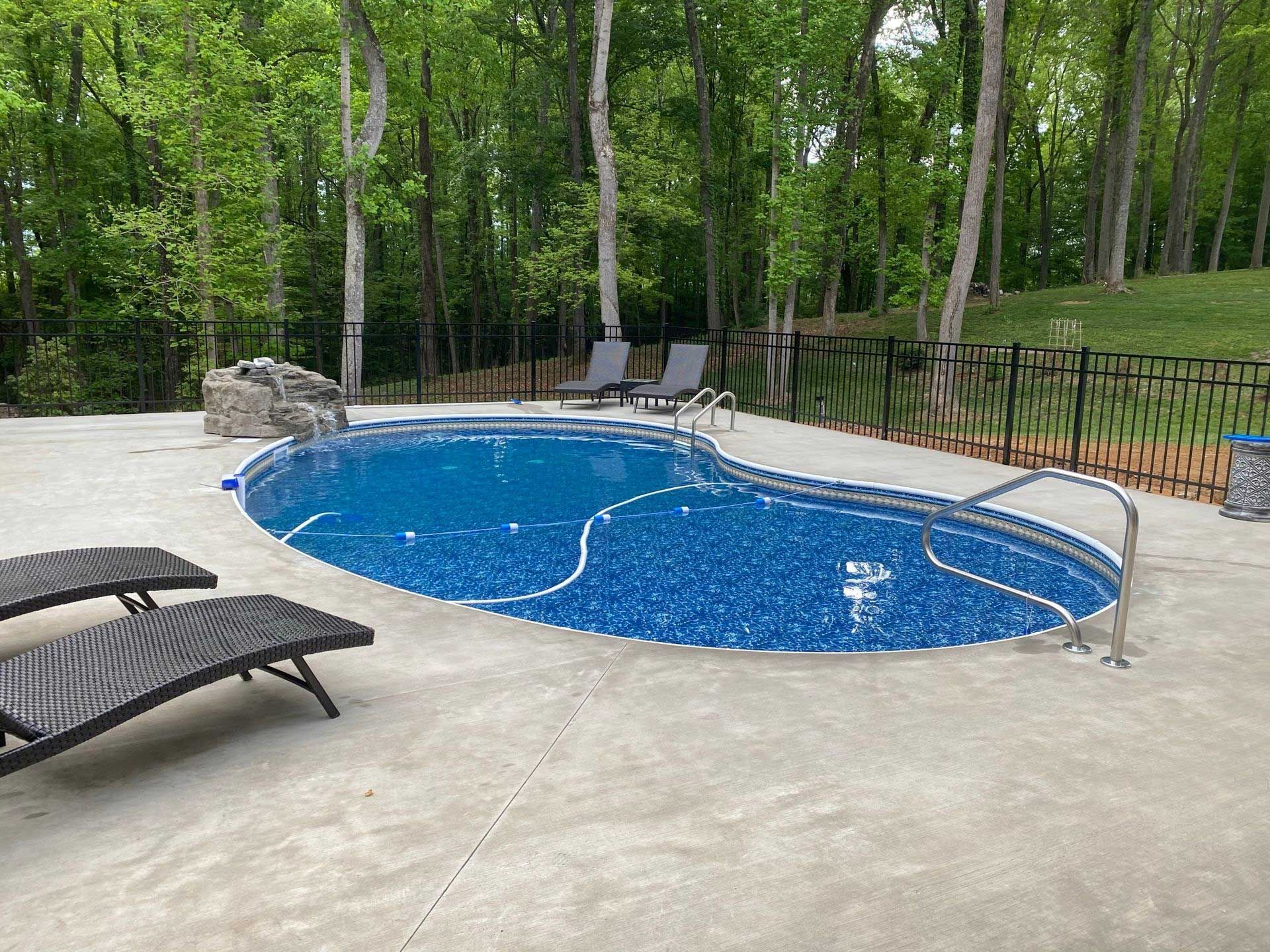 bean-shaped pool with waterfall feature