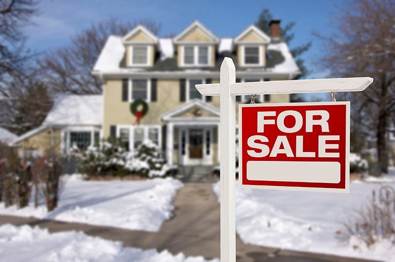 Snowy suburban house with a red 