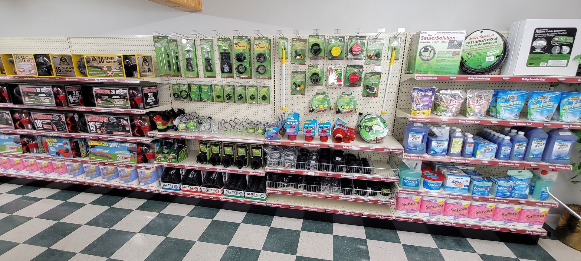 Shelves of packaged products in a store, including tools, toys, and cleaning supplies.