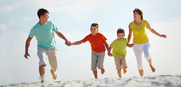family running at the beach