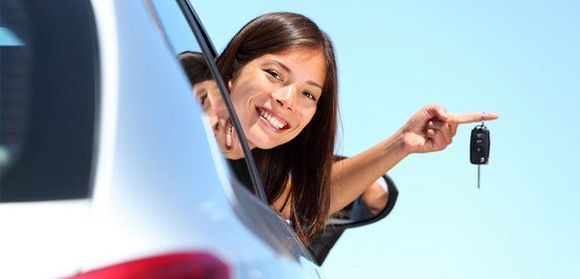 happy woman holding car key