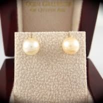 Pearl stud earrings in a display case.