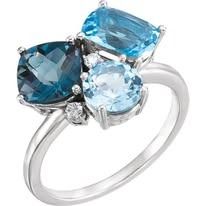 Silver ring with three blue topaz stones, and a small diamond accent.