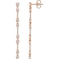 Rose gold dangle earrings with multiple round clear gemstones.
