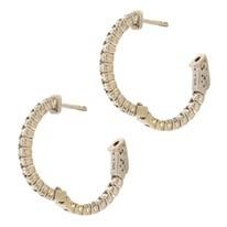 Gold hoop earrings with small, sparkling stones.