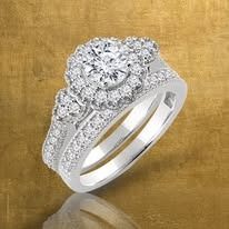 Diamond ring with a large center stone and smaller side stones, set in white gold.