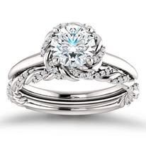 Diamond engagement ring with floral design on a white background.