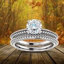 Diamond engagement ring set on wooden planks, fall foliage background.