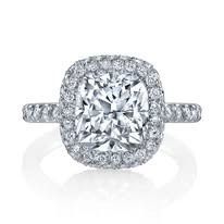 Diamond ring with a square-cut center stone and halo, set on a white band with pave diamonds.