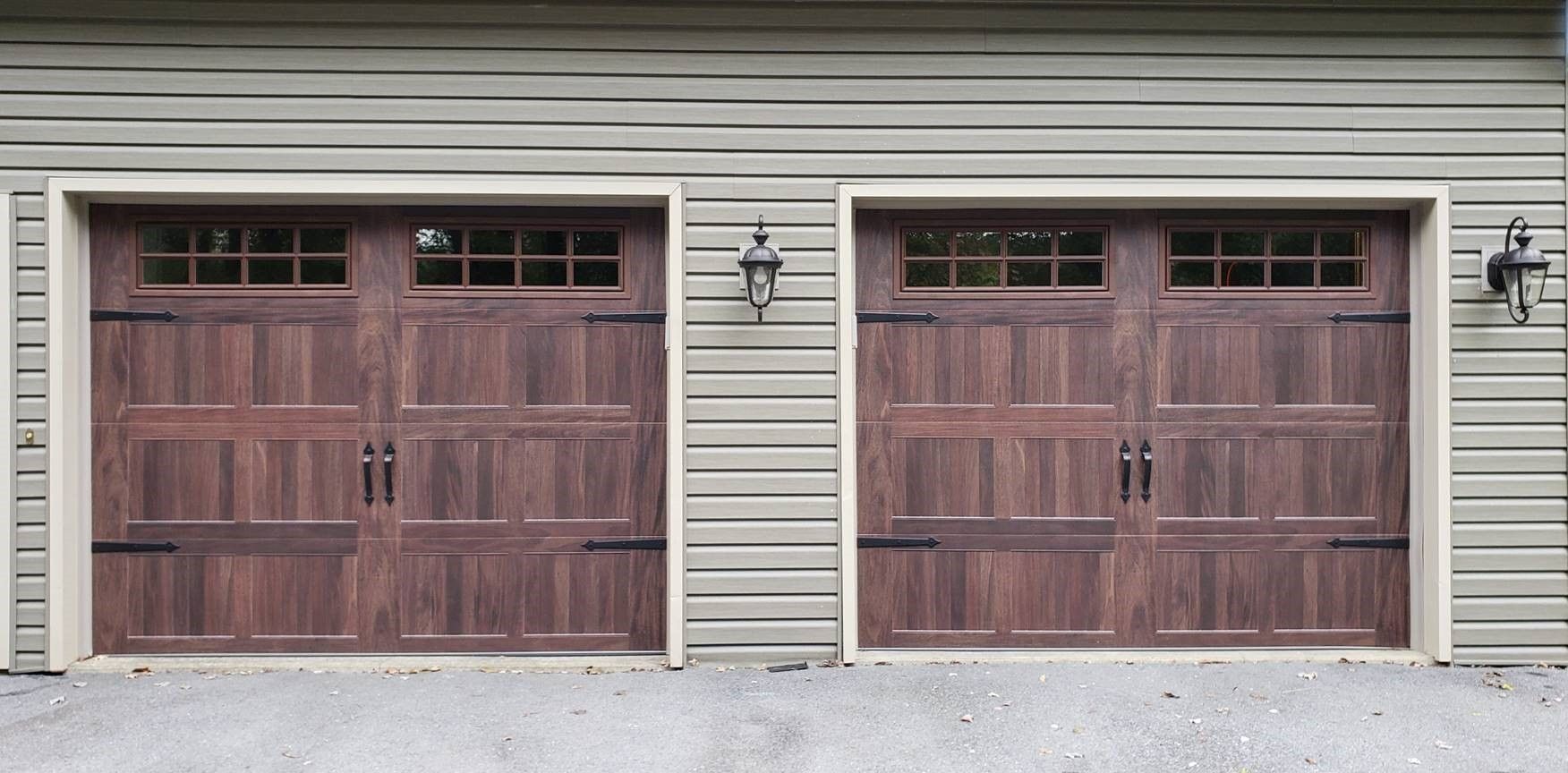 A pair of wooden garage doors on a house
