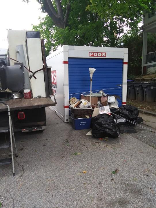 A truck is parked in front of a pods storage unit.
