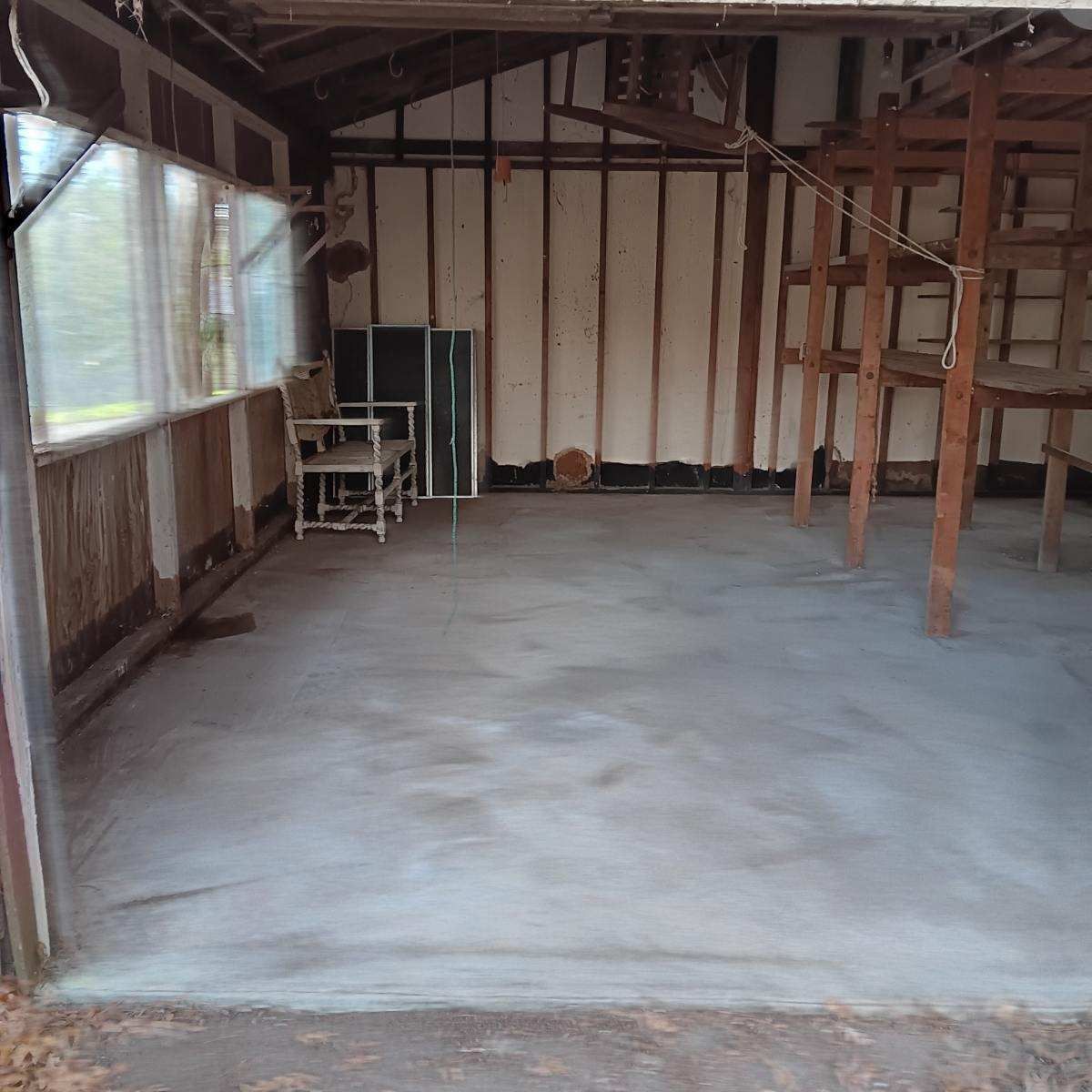 an empty room with a chair and a table in it