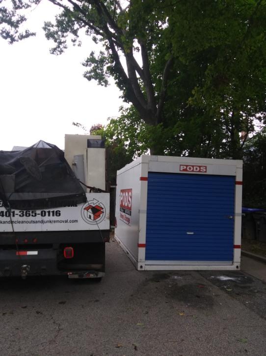 A tow truck with the number 401-365-0116 on the back