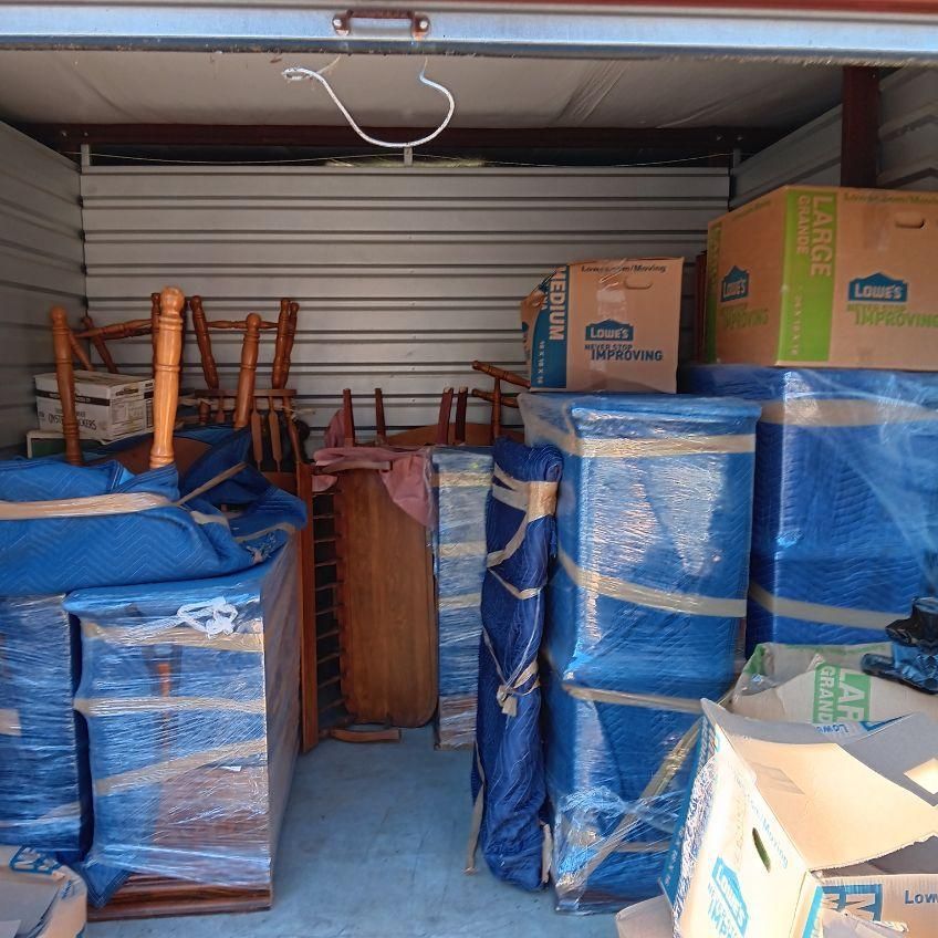 a lot of boxes in a garage with one that says lowe 's on it